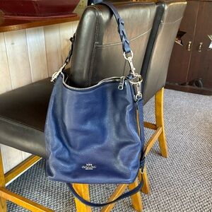 Navy blue Coach purse. Can be a cross body. Pocket inside and outside